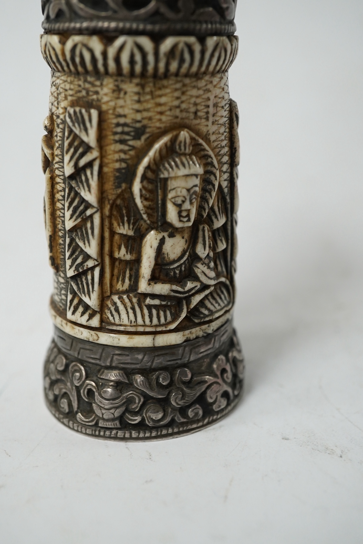 A Tibetan bone and repousse work seal, late 19th/early 20th century, 15cm high. Condition - fair